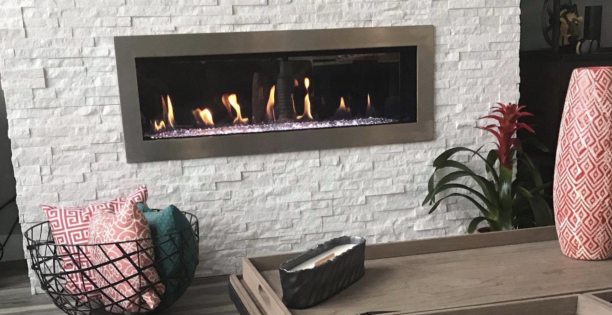 Linear gas fireplace with white stacked stone surround installed by Elite HVAC in Herriman, Utah